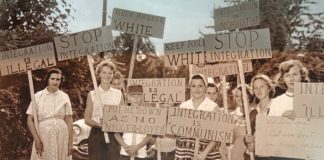 Pro-Segregationists with Quote from Supreme Court Decision on Integration demonstrating for segregation september 1957 in Little Rock. Central High School Visitors Center - Little Rock - Arkansas - USA. Photo of picture taken on May 16, 2012 by Adam Jones. (CC BY-SA 2.0).