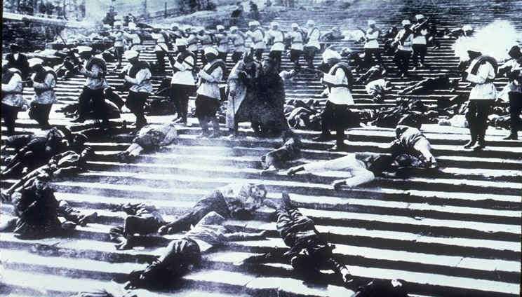 Tsarist soldiers march down the "Odessa Steps" from the Goskino film Battleship Potemkin, by Eisenstein (1925). Public Domain.