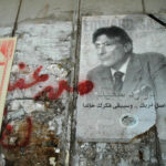 In Memoriam Edward Wadie Said: Ramallah, Graffiti on the West Bank separation wall and a Palestinian National Initiative poster of Professor Edward Said: Scholar, Activist, Palestinian 1935 – 2003 Palestine. Photo: Taken on 24 August 2004 by Justin McIntosh. (CC BY 2.0).