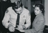 Rosa Parks being fingerprinted in February 22, 1956 by Deputy Sheriff D.H. Lackey following her arrest on December 1, 1955 for refusing to give up her seat for a white passenger on a segregated municipal bus in Montgomery, Alabama. Photo: Associated Press; restored by Adam Cuerden. Public Domain.
