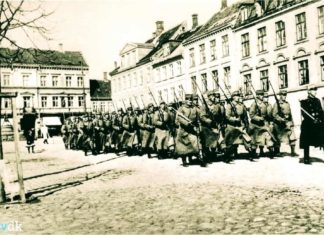 Generalstrejken i 1922. Soldater marcherer med opplantede bajonetter på Frederiksplads. (Isenkram Centret genkendes) Foto: Ukendt / Randers Stadsarkiv.