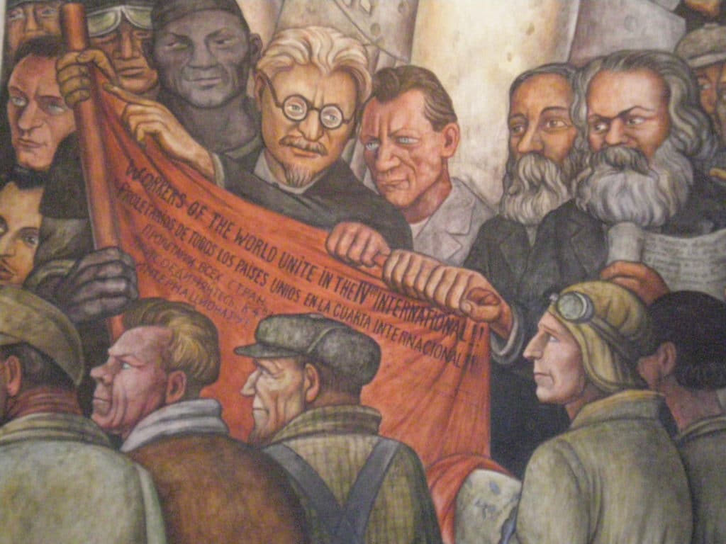 Detail from Diego Rivera's fresco 'Man at the Crossroads' at the Palace of Fine Arts, Mexico City. There are notably represented Leon Trotsky, holding the red flag of the Fourth International, Friedrich Engels and Karl Marx (pass the cursor of the mouse on the image to identify them). Date of photo: August 28, 2009. Author Painting: Diego Rivera; photo: Lock. (CC BY 3.0).