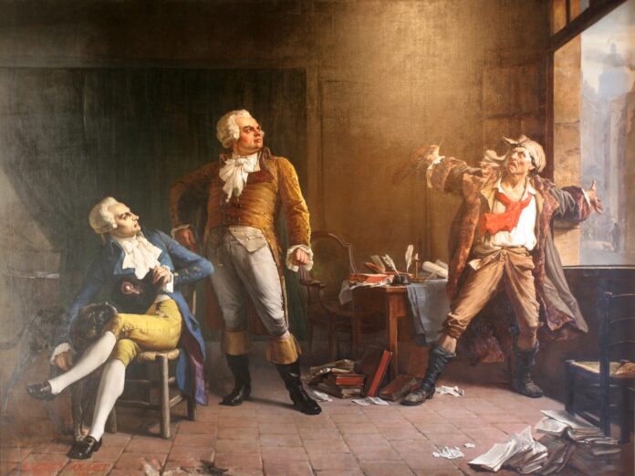 Marat Having a Animated Conversation with Danton (standing) and Robespierre (seated). Oil on canvas painted in 1882 by Alfred Loudet (1836–1898), French painter. Collection: Musée de la Révolution française. Source/Photographer: David Monniaux, 2010-07-03. Public Domain.