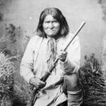 Geronimo (Goyathlay), a Chiricahua Apache; full-length, kneeling with rifle, 1887. Photo: Ben Wittick (1845–1903). Record creator: Department of Defense. Department of the Army. Office of the Chief Signal Officer. (09/18/1947 – 02/28/1964). Public Domain.