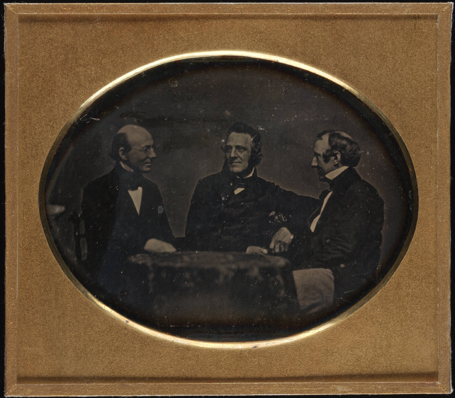 Garrison and fellow abolitionists George Thompson and Wendell Phillips, seated at table, daguerreotype, ca. 1850–1851. Author/Creator: Southworth and Hawes, Boston. Cite as: Yale Collection of American Literature, Beinecke Rare Book and Manuscript Library. (CC BY 2.0)