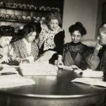 Meeting of Women’s Social and Political Union, Flora Drummond, Christabel Pankhurst, Annie Kenney, Emmeline Pankhurst, Charlotte Despard with two others, working round a kitchen table; printed inscription on reverse ‘Barratt’s Photo Press Agency, 8 Salisbury Ct, Fleet St, EC’. Photo: The Women’s Library collection/Library of the London School of Economics and Political Science. No known copyright restrictions.