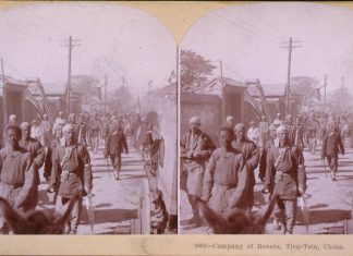 Company of Boxers, Tien-Tsin, China (photograph: The Whiting View Company, 1901). The Opium Wars and Boxer Rebellion were violent products of nineteenth-century contact between China and the West. Although British operations in China during the period are well documented, few photographs of the Chinese Boxer troops survive. Originating in the mid-nineteenth century, the stereograph was an ancestor of the newsreel, affording Americans a window on the remote corners of the globe. 1901. Source: Library of Congress. Author: Museum of Photographic Arts Collections. Publiuc Domain.