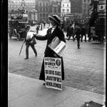 Title: Angleterre Suffragette. The suffragette is selling the ‘Votes for Women’ newspaper outside Morley’s Hotel in Trafalgar Square. The ‘Votes for Women’ newspaper was one of several suffragette newspapers published during the early years of the 20th century, this particular edition was published on Friday 29th April 1910.  1900-1919. Photo: Ch. Chusseau-Flaviens. George Eastman House Collection. No known copyright restrictions.