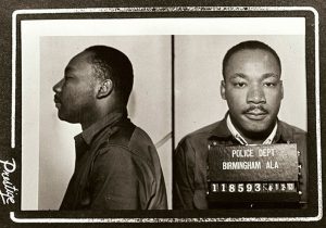 Mugshot of Martin Luther King Jr following his 1963 arrest in Birmingham. Date: April 1963. Original publication: circulated to news media in April 1963. Author: Birmingham AL police dept, Public Domain. Source: <a href="https://commons.wikimedia.org/wiki/File:MLK_mugshot_birmingham.jpg">Wikimedia Commons</a>