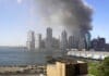 This is a panorama stitched together from 4 photos taken on the morning of September 11, 2001 from the Brooklyn Promenade. Photo: Jeffrey Bary. (CC BY 2.0).