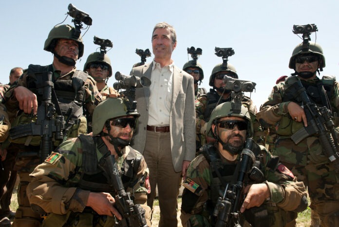 NATO Secretary General Anders Fogh Rasmussen, poses with a Afghan special forces at Camp Morehead, Afghanistan, April 12. 2012. Photo: Taken by ResoluteSupportMedia / Maitre Christian Valverde, French Navy, ISAF Public Affairs Office. (CC BY 2.0).