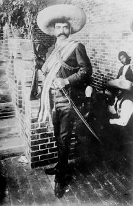 Emiliano Zapata. Source : http://memory.loc.gov/service/pnp/ggbain/14900/14906v.jpg Author: Bain News Service, publisher. Public Domain (Library of Congress, Prints & Photographs Division, [reproduction number, e.g., LC-B2-1234]) No known restrictions on publication.