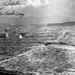 Destructed Hiroshima with autograph of “Enola Gay” Bomber pilot Paul Tibbets. Photo: US Navy. Post-Work: User:W.wolny. Public Domain.