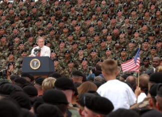 President George W. Bush addresses troops and families of the 10th Mountain Division and other members of the Fort Drum Community at Fort Drum, N.Y., July 19, 2002. Series: Photographs Related to the George W. Bush Administration, 1/20/2001 - 1/20/2009 Collection: Records of the White House Photo Office (George W. Bush Administration), 1/20/2001 - 1/20/2009. Public Domain.