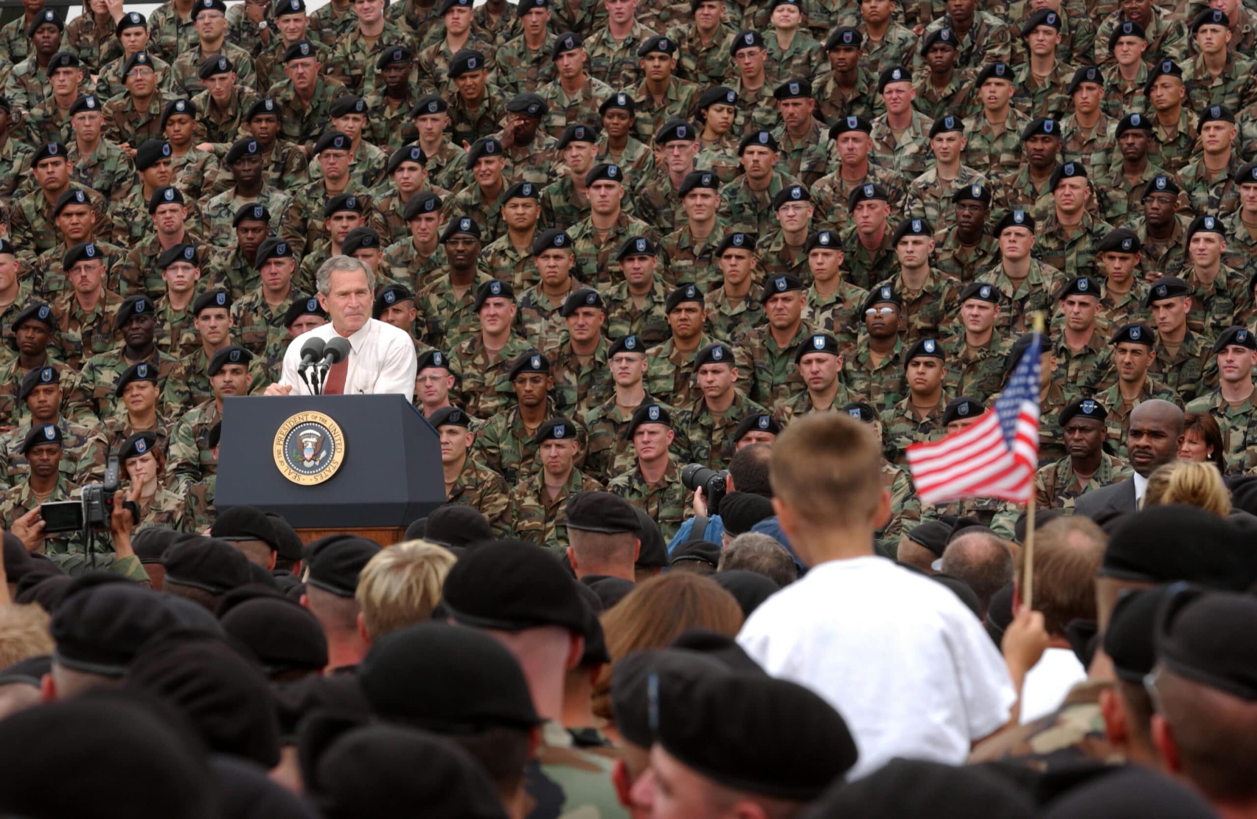 President George W. Bush addresses troops and families of the 10th Mountain Division and other members of the Fort Drum Community at Fort Drum, N.Y., July 19, 2002. Series: Photographs Related to the George W. Bush Administration, 1/20/2001 - 1/20/2009 Collection: Records of the White House Photo Office (George W. Bush Administration), 1/20/2001 - 1/20/2009. Public Domain.