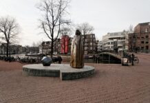 Amsterdam - Zwanenburgwal / Amstel - View West on Statue of Benedictus de Spinoza. Statue made 2008 by Nicolaas Lambertus Maria (Nicolas) Dings (1953-), Dutch sculptor and draughtsman. Photo: Taken 2008 by Txllxt TxllxT. (CC BY-SA 4.0).