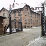The “Arbeit macht frei” sign at the main gate of the Auschwitz I concentration camp in German-occupied Poland. Photo: Taken 27 November 2005 by Tulio Bertorini. (CC BY-SA 2.0).
