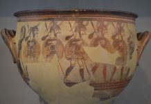Mycenae, Warrior's Vase, Helladic Period/Civilization. Large krater depicting men in full armour as they depart for war, a sack of supplies hanging from their spears, to the side a woman raises her hand in a farewell gesture, from Mycenae Acropolis, 12th century BC. Collection: National Archaeological Museum of Athens. Photo: Taken on April 18, 2014 by Carole Raddato. (CC BY-SA 2.0).