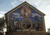 Ireland's Holocaust mural on the Ballymurphy Road or Whiterock road?, Belfast. "An Gorta Mór, Britain's genocide by starvation, Ireland's holocaust 1845–1849, over 1,500,000 deaths". Photo: Miossec. (CC BY-SA 3.0).