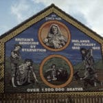 Ireland’s Holocaust mural on the Ballymurphy Road or Whiterock road?, Belfast. “An Gorta Mór, Britain’s genocide by starvation, Ireland’s holocaust 1845–1849, over 1,500,000 deaths”. Photo: Miossec. (CC BY-SA 3.0).