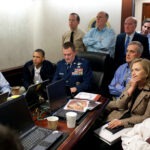 The Situation Room. U.S. President Barack Obama and Vice President Joe Biden, Hillary Clinton along with members of the national security team, receive an update on Operation Neptune Spear, a mission against Osama bin Laden, in one of the conference rooms of the Situation Room of the White House, May 1, 2011. They are watching live feed from drones operating over the bin Laden complex. Photo: taken 1 May 2011 by Peter  Souza, (1954-), Official White House Photographer. Public Domain.