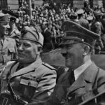 Hitler_and_Mussolini_in_Munich,_Hitler and Mussolini in Munich, Germany, circa June 1940. Eva Braun’s Photo Albums, ca. 1913-ca. 1944. General Services Administration, U.S. National Archives and Records Service. Office of the National Archives, ca. 1949-1985. Record Group 242: National Archives Collection of Foreign Records Seized, 1675-1958. Public Domain.