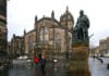 Adam Smith statue in Edinburgh's High Street with St. Giles High Kirk behind. Photo taken 23 November 2018 by Andraszy. (CC BY-SA 4.0).