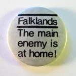 Falklands: The Main Enemy is at Home. The Falklands War began with the Argentinean invasion of Falkland Islands in April 1982, and ended with their recapture two and a half months later by British forces.’The main enemy is at home’ is an anti-imperialist slogan of Karl Liebknecht, the German socialist revolutionary. The implication is that opposition to one’s own ruling class is more important than loyalty to the state during wartime. Photo: Danny Birchall. (CC BY 2.0).
